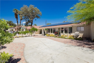 Rear view of property with a tiled roof, solar pan