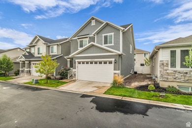 Craftsman-style house featuring concrete driveway and stone siding