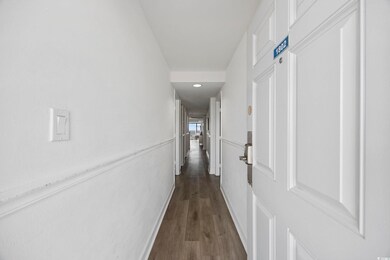 Hall with dark wood-type flooring