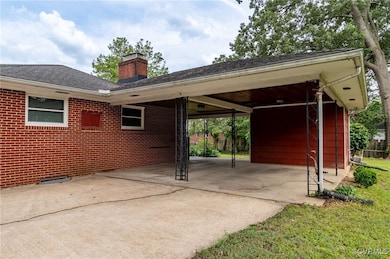 View of parking featuring concrete driveway and an