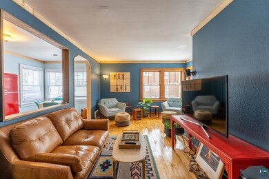 Living room featuring crown molding and hardwood /