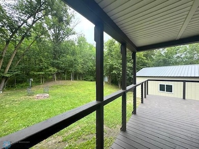 Covered deck overlooking firepit area