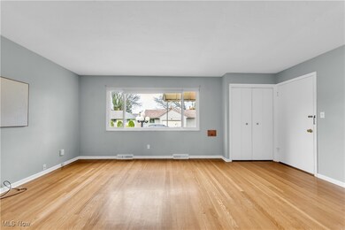 Empty room featuring visible vents, baseboards, and wood finished floors