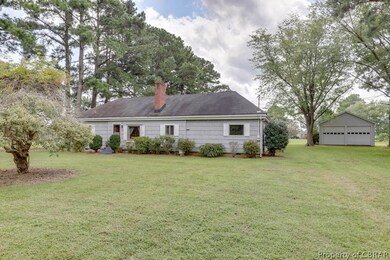 Cottage w/large detached garage at rear.