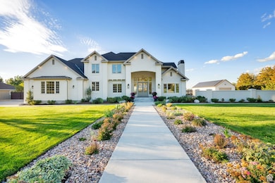 View of front facade with a chimney, a metal roof, french doors, and a standing seam roof