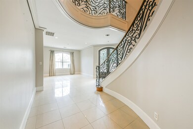 Soaring ceilings and a dramatic curved staircase