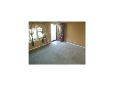 Living Room. Newer carpet, front door and bay wind