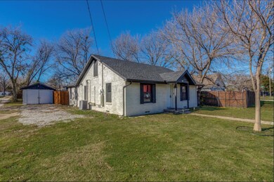 View of front of house featuring a storage unit, a