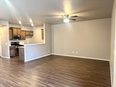 Kitchen featuring brown cabinets, dark wood finish