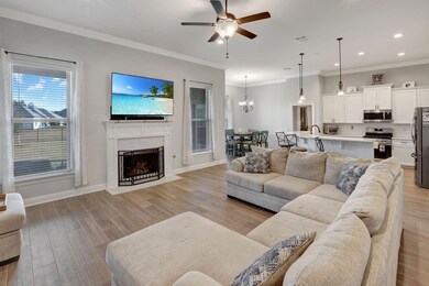 Gas fireplace in Den wth picture windows looking o