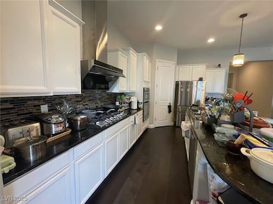 Kitchen with wall chimney exhaust hood, stainless
