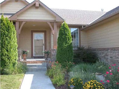 Lush landscaping invites you into this warm and in