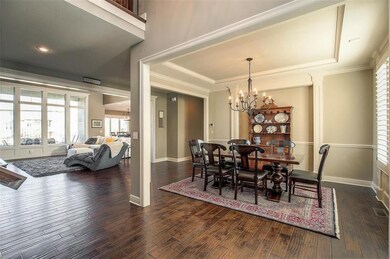 Large formal dining room with gleaming hardwoods t