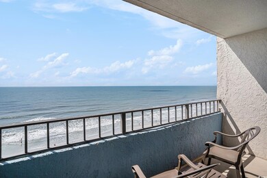 Balcony with view of water and beach