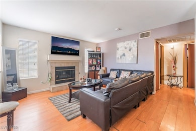Unit A Living area with light wood-style floors, a