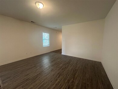 Spare room with dark wood-type flooring