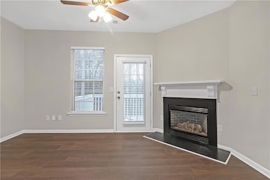 Unfurnished living room featuring ceiling fan and 