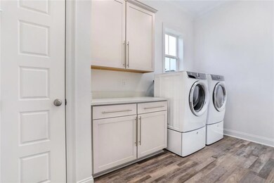 Laundry room w/ washer & dryer. Folding station an