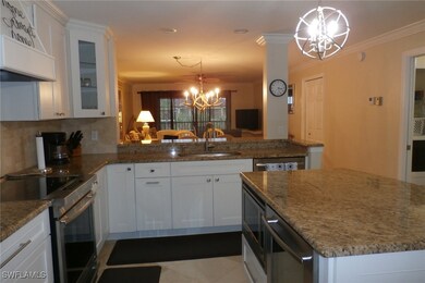 Kitchen featuring white cabinetry, a notable chand
