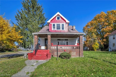 Bungalow featuring a front yard and covered porch