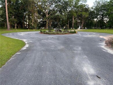 View of asphalt street featuring view of scattered trees