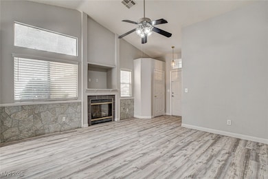 Unfurnished living room featuring ceiling fan, hig