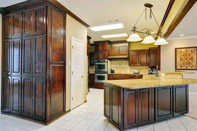 Kitchen with double ovens and ceramic tile floorin