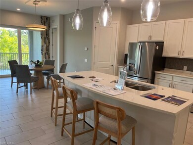 Kitchen with a sink, backsplash, white cabinetry, 