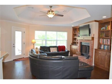 Living room has a custom octagonal tray ceiling an