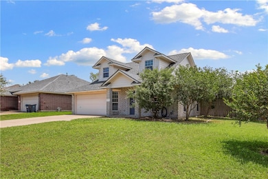 View of front of home with an attached garage, con