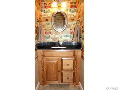The fun half bath downstairs has new flooring, new