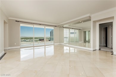 Empty room featuring baseboards, ornamental moldin