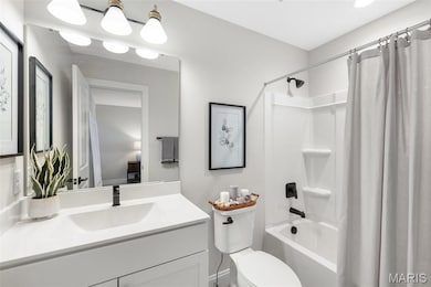 Bathroom with shower / tub combo with curtain and vanity