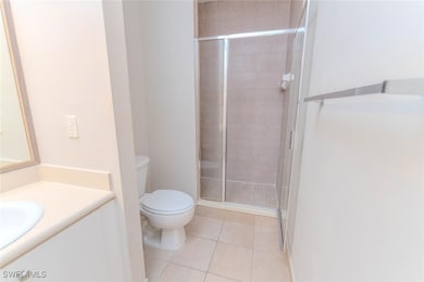 Full bath featuring toilet, vanity, a stall shower