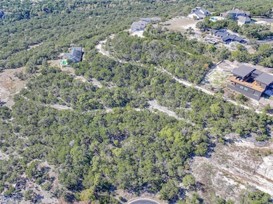 View of property location featuring a forest
