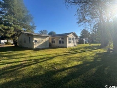 View of property exterior featuring a yard