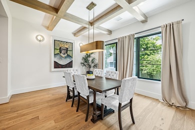 Spacious dining room with stylish chandelier.