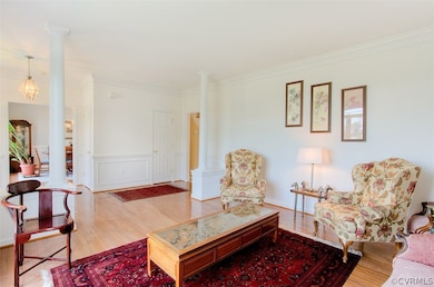 Formal Living Room. Hardwood floors, picture frame molding, & crown molding.