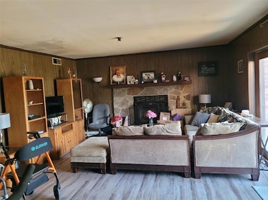 Living area featuring visible vents, wood finished