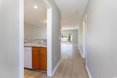 Hallway with recessed lighting, light wood-style f