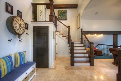 Entry with travertine tile flooring