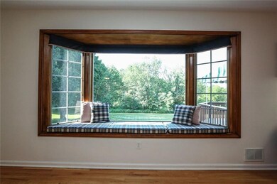 Huge bay window seats looks out onto beautiful bac
