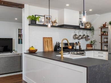 Kitchen with stainless steel gas range oven, dark