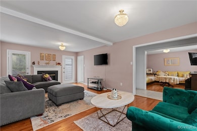 Living room featuring beam ceiling, wood finished