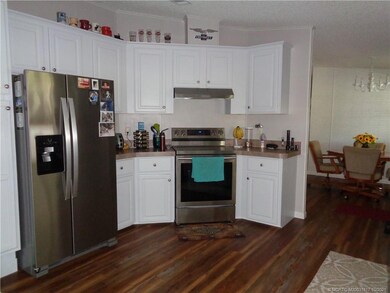 Kitchen showing Refrigerator, Range, Flooring