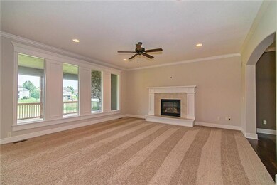 The great room showcases a wall of windows and coz