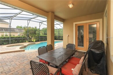 Spacious covered porch overlooking sparkling pool