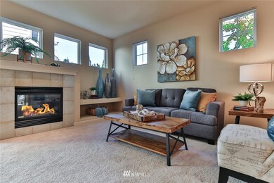 Light fills the living room from the abundant amount of windows.  There are built in shelves for the television and media equipment.  The carpet is new on the main level of the home.