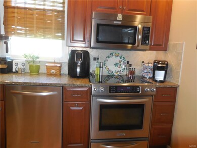 new appliances with granite counters and tile back