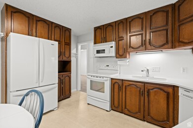 Kitchen with new white appliances and plenty of kitchen space.